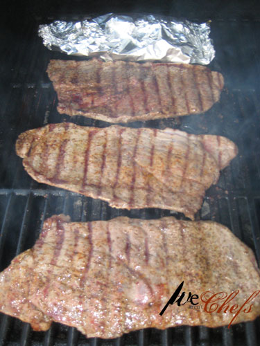 Grilling steaks for cheesesteak sandwiches